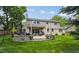 Beautiful backyard featuring a stone patio, outdoor furniture, grill, and manicured lawn at 5766 S Fulton Way, Greenwood Village, CO 80111