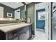 Charming bathroom with marble vanity and patterned tile flooring, connecting to separate toilet space at 5766 S Fulton Way, Greenwood Village, CO 80111