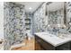 Stylish bathroom with vibrant wallpaper and a marble vanity at 5766 S Fulton Way, Greenwood Village, CO 80111