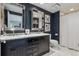 Elegant bathroom with double marble vanity, decorative mirrors, and a shower with blue accent wall at 5766 S Fulton Way, Greenwood Village, CO 80111