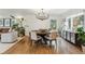 Elegant dining room with a modern chandelier, hardwood floors, and ample space for entertaining at 5766 S Fulton Way, Greenwood Village, CO 80111