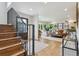 Bright entryway featuring hardwood floors, a staircase with iron railings, and a view into the living room at 5766 S Fulton Way, Greenwood Village, CO 80111