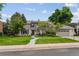 Charming home with a well-maintained lawn, mature trees, and a welcoming entryway at 5766 S Fulton Way, Greenwood Village, CO 80111