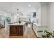 Bright kitchen with a large central island, white cabinets, and open layout at 5766 S Fulton Way, Greenwood Village, CO 80111