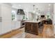 Spacious kitchen featuring a large island, modern appliances, and a seamless flow to the living area at 5766 S Fulton Way, Greenwood Village, CO 80111