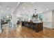 Spacious open kitchen featuring a large island with seating and modern lighting fixtures at 5766 S Fulton Way, Greenwood Village, CO 80111