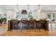 Stylish kitchen with a central island, seating for four, and modern pendant lighting at 5766 S Fulton Way, Greenwood Village, CO 80111