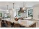 Updated kitchen with large marble island, stainless steel appliances, and stylish lighting at 5766 S Fulton Way, Greenwood Village, CO 80111