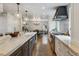 Updated kitchen featuring stainless appliances, island with sink, and ample counter space at 5766 S Fulton Way, Greenwood Village, CO 80111