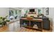 Bright living room with fireplace, hardwood floors, and access to the outdoor patio at 5766 S Fulton Way, Greenwood Village, CO 80111