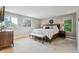 Spacious main bedroom featuring plush carpeting, large windows, and a decorative wreath detail at 5766 S Fulton Way, Greenwood Village, CO 80111