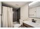 Tastefully updated bathroom with modern gray tiling and shower curtain, combining style and function at 10785 W 63Rd Pl # 108, Arvada, CO 80004