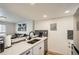 Kitchen showcases stone countertops, stainless steel appliances, a sleek backsplash, and seamless open-concept design at 10785 W 63Rd Pl # 108, Arvada, CO 80004