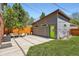 Modern backyard features a patio with a green door and well-maintained landscaping at 814 S High St, Denver, CO 80209
