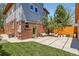 Charming backyard features a brick accent wall, green door, and outdoor seating area at 814 S High St, Denver, CO 80209