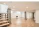 Spacious finished basement with wood-look flooring, exposed brick pillars, and recessed lighting at 814 S High St, Denver, CO 80209