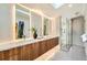Modern bathroom with a double sink vanity, a glass-enclosed shower, and stylish tile work at 814 S High St, Denver, CO 80209