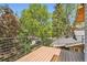 A modern deck showcases neighborhood trees and a car driving on the road at 814 S High St, Denver, CO 80209