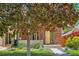 Charming home with brick exterior, mature trees, green lawn, and well-maintained landscaping at 814 S High St, Denver, CO 80209