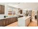 Stylish kitchen featuring a center island with seating, stainless steel appliances, and hardwood floors at 814 S High St, Denver, CO 80209