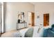 Bright main bedroom featuring a stylish console table, modern décor, and access to an ensuite bathroom and walk-in closet at 814 S High St, Denver, CO 80209