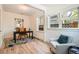 Inviting office space featuring hardwood floors, a cozy sitting area, and ample natural light from multiple windows at 814 S High St, Denver, CO 80209