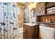 Charming bathroom featuring wood-look tile, updated fixtures and a fun shower curtain at 801 Hanover St, Aurora, CO 80010