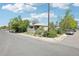Charming single-story home featuring classic siding and a cozy front porch, surrounded by mature trees on a sunny day at 801 Hanover St, Aurora, CO 80010