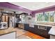 Bright kitchen with stainless steel appliances, mosaic backsplash, farmhouse sink and wood floors at 801 Hanover St, Aurora, CO 80010