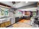Bright kitchen featuring stainless steel appliances, mosaic backsplash, wood and ceramic floors at 801 Hanover St, Aurora, CO 80010