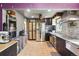 Bright kitchen with stainless steel appliances, mosaic backsplash, and tan ceramic floors at 801 Hanover St, Aurora, CO 80010