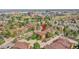 Aerial perspective shows a desirable apartment complex nestled among mature trees and landscaping at 201 Wright St # 105, Lakewood, CO 80228