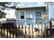 This backyard features a gray house with a view of the yard and a wood fence at 10515 W Dartmouth Ave, Lakewood, CO 80227