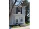 Charming townhome with white trim, black shutters, and well-maintained front lawn at 10515 W Dartmouth Ave, Lakewood, CO 80227