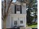 Charming townhome with white trim, black shutters, and well-maintained front lawn at 10515 W Dartmouth Ave, Lakewood, CO 80227