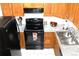 Efficient kitchen layout with black appliances, ample counter space, and classic cabinetry at 10515 W Dartmouth Ave, Lakewood, CO 80227