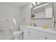 This remodeled bathroom features a toilet, shower and modern vanity at 2301 Dunbar Ct, Longmont, CO 80501