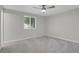 This bedroom features soft grey carpet, ceiling fan and a bright window at 2301 Dunbar Ct, Longmont, CO 80501
