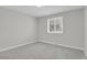 This bedroom features soft grey carpet, ceiling fan and a bright window at 2301 Dunbar Ct, Longmont, CO 80501