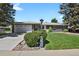 A charming single-story home with a well-manicured lawn and an attached two-car garage at 2301 Dunbar Ct, Longmont, CO 80501