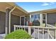 Inviting front porch with a seating area, decorative details, and attractive landscaping at 2301 Dunbar Ct, Longmont, CO 80501