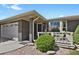 Charming front porch features brick columns, seating area, and beautiful landscaping at 2301 Dunbar Ct, Longmont, CO 80501