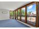 The sunroom has wood trim windows and views of the landscaped backyard at 2301 Dunbar Ct, Longmont, CO 80501