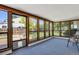 Bright sunroom with wood trim windows overlooking the landscaped yard at 2301 Dunbar Ct, Longmont, CO 80501