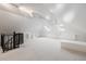 Finished attic space featuring bright white walls, carpeted floors, and a ceiling fan at 1521 Pontiac St, Denver, CO 80220