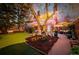 Beautiful backyard with dining and lounge areas, surrounded by lush landscaping and mature trees at 1521 Pontiac St, Denver, CO 80220