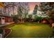 Lush backyard with well-manicured lawn, mature trees and shrubbery, creating a private oasis at 1521 Pontiac St, Denver, CO 80220