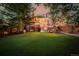 Expansive backyard features lush green lawn, mature trees, and an inviting patio area at 1521 Pontiac St, Denver, CO 80220