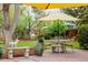 Landscaped backyard with patio featuring seating, garden decor and green foliage at 1521 Pontiac St, Denver, CO 80220