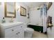 Stylish bathroom featuring a clawfoot tub, gold accents and white vanity at 1521 Pontiac St, Denver, CO 80220